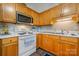 Well-lit kitchen boasts wooden cabinetry, sleek countertops, modern appliances, and durable vinyl floors at 1100 22Nd Ne St # 502, Hickory, NC 28601