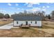 Back of home with a wooden deck perfect for enjoying the outdoors at 111 Proust Rd, Statesville, NC 28625