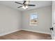 Cozy bedroom with a ceiling fan, wood-look floors, and a window view at 111 Proust Rd, Statesville, NC 28625