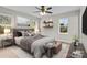 Comfortable bedroom with large windows, stylish decor, and hardwood floors offers a serene and inviting space at 111 Proust Rd, Statesville, NC 28625