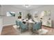 Bright dining room featuring stylish marble table, modern chairs, neutral decor, and lots of natural light at 111 Proust Rd, Statesville, NC 28625