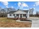 Charming single-story home with a welcoming front porch and well-maintained lawn at 111 Proust Rd, Statesville, NC 28625