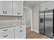 Close-up of the kitchen area, featuring stainless steel refrigerator and granite countertops at 111 Proust Rd, Statesville, NC 28625