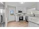 Bright kitchen featuring stainless appliances, granite counters, and a door leading to the outdoors at 111 Proust Rd, Statesville, NC 28625