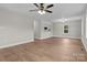 Spacious living room features modern flooring, fresh paint and ceiling fan at 111 Proust Rd, Statesville, NC 28625