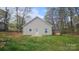 Backyard with a shed, freshly cut grass and a newly built house with beige siding and white trim at 1124 Clouse St, Gastonia, NC 28052