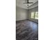 Spacious bedroom boasts wood-look floors, a tray ceiling, and lots of natural light from three windows at 1124 Clouse St, Gastonia, NC 28052