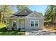 Charming single-story home with a cozy front porch and well-maintained lawn at 1124 Clouse St, Gastonia, NC 28052