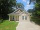 Charming single-story home with a covered front porch and a spacious driveway at 1124 Clouse St, Gastonia, NC 28052