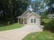 Inviting home featuring a covered porch, light siding, and a neatly paved driveway at 1124 Clouse St, Gastonia, NC 28052