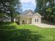 Attractive home featuring a covered porch, light siding, lush lawn and private driveway at 1124 Clouse St, Gastonia, NC 28052