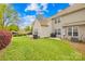 Private backyard featuring a well-maintained lawn and mature landscaping, ideal for outdoor enjoyment at 11308 Morgan Valley Ln, Charlotte, NC 28270