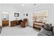 Bright bedroom features a vaulted ceiling, a ceiling fan, and a cozy sitting area next to the window at 11308 Morgan Valley Ln, Charlotte, NC 28270