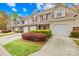 Well-maintained townhomes with single car garages, attractive landscaping, and colorful accents at 11308 Morgan Valley Ln, Charlotte, NC 28270