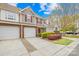 Attractive townhome featuring a single car garage, red shutters, and a well-manicured front yard at 11308 Morgan Valley Ln, Charlotte, NC 28270