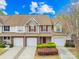Charming townhome with a well-maintained front yard, single car garage, and brick and siding facade at 11308 Morgan Valley Ln, Charlotte, NC 28270