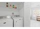Functional laundry room with washer, dryer, and shelving at 11308 Morgan Valley Ln, Charlotte, NC 28270