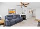 Cozy living room with a fireplace, plush sofa, and view into the kitchen, creating a welcoming space at 11308 Morgan Valley Ln, Charlotte, NC 28270