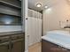 Well-lit bathroom featuring a modern sink, shower with curtain, and built-in storage at 119 Dills Dr, Dallas, NC 28034
