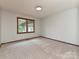 A bright, carpeted room with a single window offering natural light and a view of the outdoors at 119 Dills Dr, Dallas, NC 28034