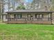 Charming ranch home with a covered front porch and well-maintained lawn at 119 Dills Dr, Dallas, NC 28034