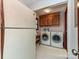 Functional laundry room featuring a washer, dryer, and built-in wooden cabinets at 119 Dills Dr, Dallas, NC 28034