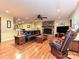 Inviting living room featuring a stone fireplace, hardwood floors, and a ceiling fan at 119 Dills Dr, Dallas, NC 28034
