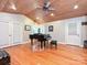 This living room features a grand piano, hardwood floors, a decorative ceiling, and access to the backyard at 119 Dills Dr, Dallas, NC 28034