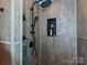 This renovated bathroom has a walk-in shower with tiled walls and modern fixtures at 119 Dills Dr, Dallas, NC 28034