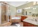 Bathroom with a glass shower, corner tub, double sinks, and neutral tile at 124 Cedar Woods Dr, Mooresville, NC 28117