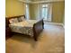 Bedroom with a queen bed and dark wood furniture at 124 Cedar Woods Dr, Mooresville, NC 28117