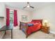 Cozy bedroom features a wooden sleigh bed, bedside table with lamp, and natural light from a window at 124 Cedar Woods Dr, Mooresville, NC 28117