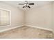 Bright bedroom with neutral carpet, ceiling fan, and a window that provides natural light at 124 Cedar Woods Dr, Mooresville, NC 28117