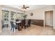 Bright dining room with natural light, tile floors, a ceiling fan, and large table at 124 Cedar Woods Dr, Mooresville, NC 28117