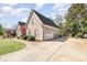 Brick home with driveway leading to attached garage, surrounded by lawn and landscaping at 124 Cedar Woods Dr, Mooresville, NC 28117