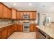 Traditional kitchen featuring wooden cabinets, stainless steel appliances, and granite countertops at 124 Cedar Woods Dr, Mooresville, NC 28117