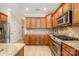 Traditional kitchen featuring wooden cabinets, stainless steel appliances, and granite countertops at 124 Cedar Woods Dr, Mooresville, NC 28117