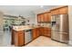 Open kitchen with stainless steel appliances, granite countertops, and wooden cabinets at 124 Cedar Woods Dr, Mooresville, NC 28117