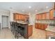 Open kitchen with stainless steel appliances, bar stool seating, and wooden cabinets at 124 Cedar Woods Dr, Mooresville, NC 28117