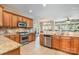 Open kitchen featuring stainless steel appliances and granite countertops at 124 Cedar Woods Dr, Mooresville, NC 28117