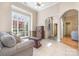 Bright living room with a large window, a loveseat, a wooden chest and vaulted ceilings at 124 Cedar Woods Dr, Mooresville, NC 28117