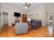 Cozy living room with hardwood floors, fireplace, and abundant natural light at 124 Cedar Woods Dr, Mooresville, NC 28117