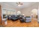 Inviting living area featuring hardwood flooring, sectional seating, and an open layout at 124 Cedar Woods Dr, Mooresville, NC 28117