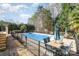 Inviting in-ground pool surrounded by wrought iron fence and a patio set for outdoor enjoyment at 124 Cedar Woods Dr, Mooresville, NC 28117