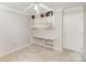 Office/bedroom with built-in bookshelves, storage shelves, and neutral carpet at 14525 Arbor Ridge Dr, Charlotte, NC 28273