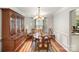 Elegant dining room featuring hardwood floors, a chandelier, and large windows for natural light at 14525 Arbor Ridge Dr, Charlotte, NC 28273