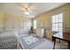 Cozy bedroom featuring a wicker daybed, dresser, and floral accents, illuminated by natural light at 1515 Paul Boyd Rd, Clover, SC 29710