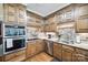 Spacious kitchen features stainless steel appliances, tile backsplash, light granite countertops and wooden cabinetry at 1515 Paul Boyd Rd, Clover, SC 29710