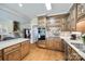 Well-lit kitchen featuring wood cabinets, granite countertops, modern appliances, and a tiled backsplash at 1515 Paul Boyd Rd, Clover, SC 29710
