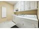 Functional laundry room with washer, dryer, sink, and ample storage cabinets at 1515 Paul Boyd Rd, Clover, SC 29710